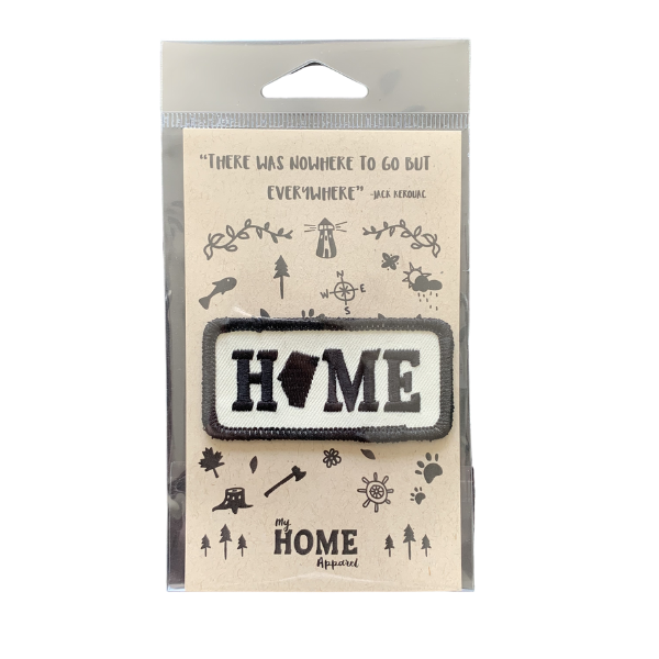 Alberta HOME Patch with black outline on a hang tag with symbols