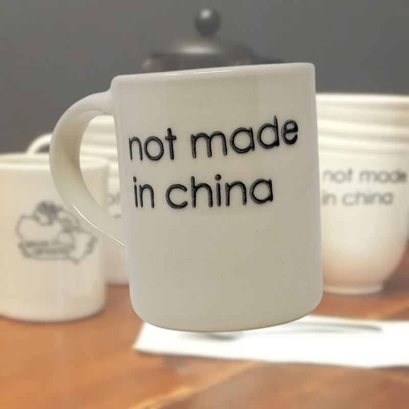 Canadian made mug on kitchen counter with other mugs in background