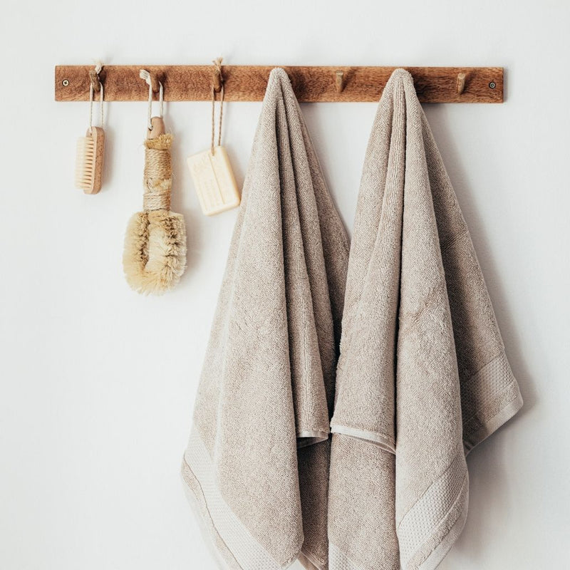 canadian made bathroom accessories with towels and natural wood hooks