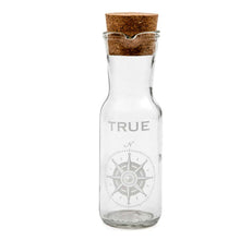 Load image into Gallery viewer, decanter with cork stopper with a compass pointing to the north and the word True written above it
