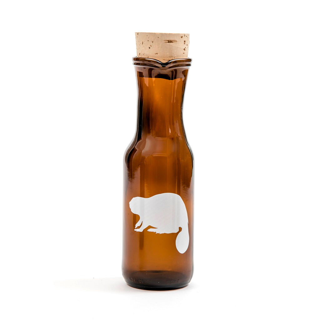 decanter with a cork stopper and the print of a beaver on it in the colour white