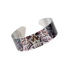 Load image into Gallery viewer, a bracelet printed with a depiction of burnt wood black, greys, browns
