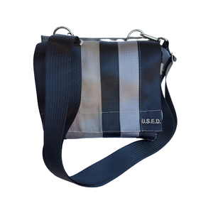 straight on front view of shoulder bag in dark and light colours with silver loops