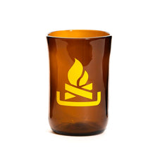 Load image into Gallery viewer, brown glass cup with yellow camp fire symbol on it
