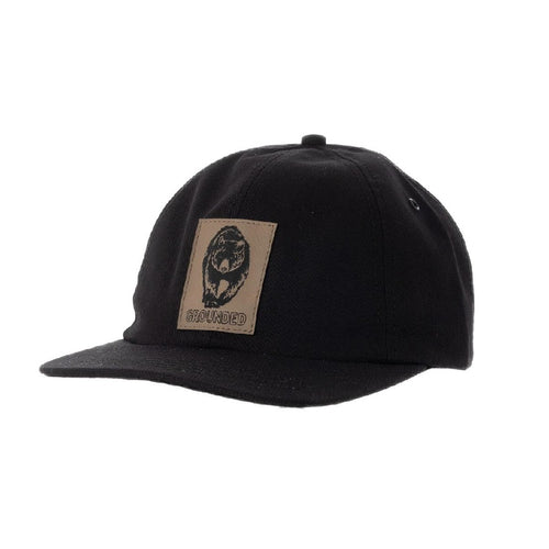 5 panel hat with black sketch of a bear on a faux leather patch