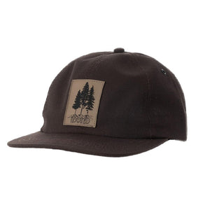 5 panel hat with black sketch of trees with roots and the word ROOTED  on a faux leather patch