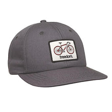 Load image into Gallery viewer, stone coloured snap back hat with a white rectangular patch of a road peddle bike on it
