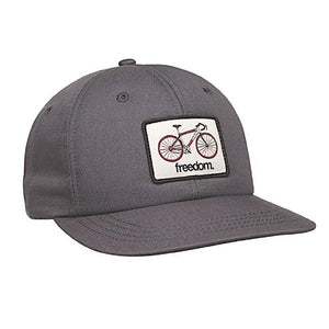 stone coloured snap back hat with a white rectangular patch of a road peddle bike on it