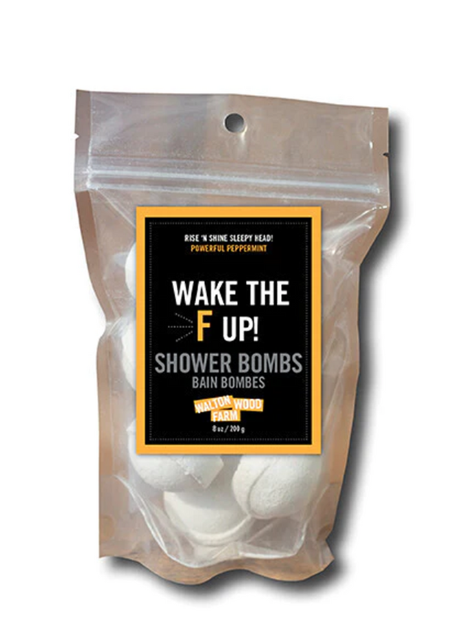 clear bag with white half circle shower bombs and a label with white writing and black background