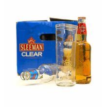 Load image into Gallery viewer, full bottle with a tall clear glass beside it and a blue box in behind
