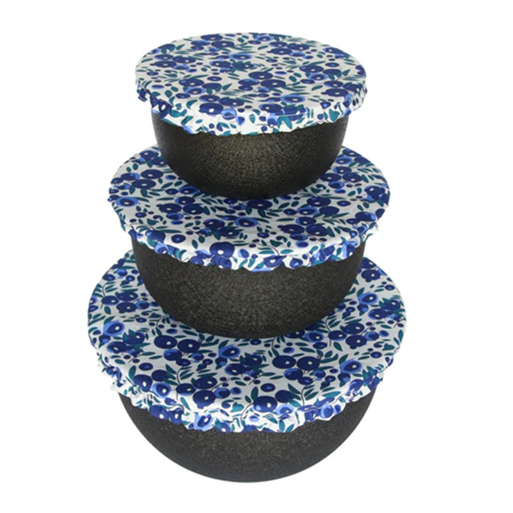 Set of three black bowls with blueberry pattern cotton bowl covers on a white background