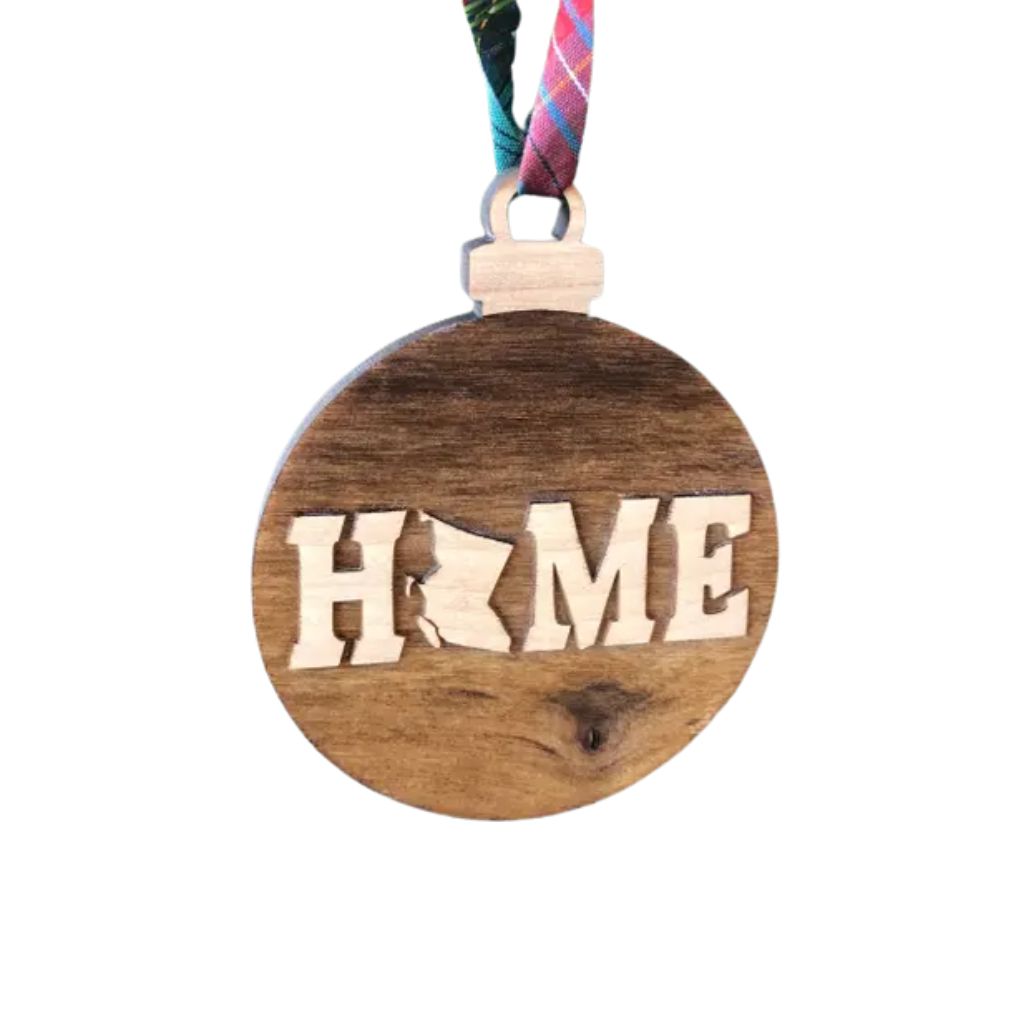 Wooden ornament with British Columbia'HOME' cutout on a white background