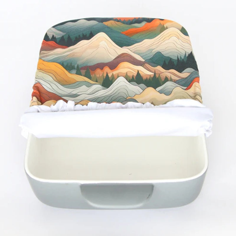 reusable casserole cover with a colorful mountain design on