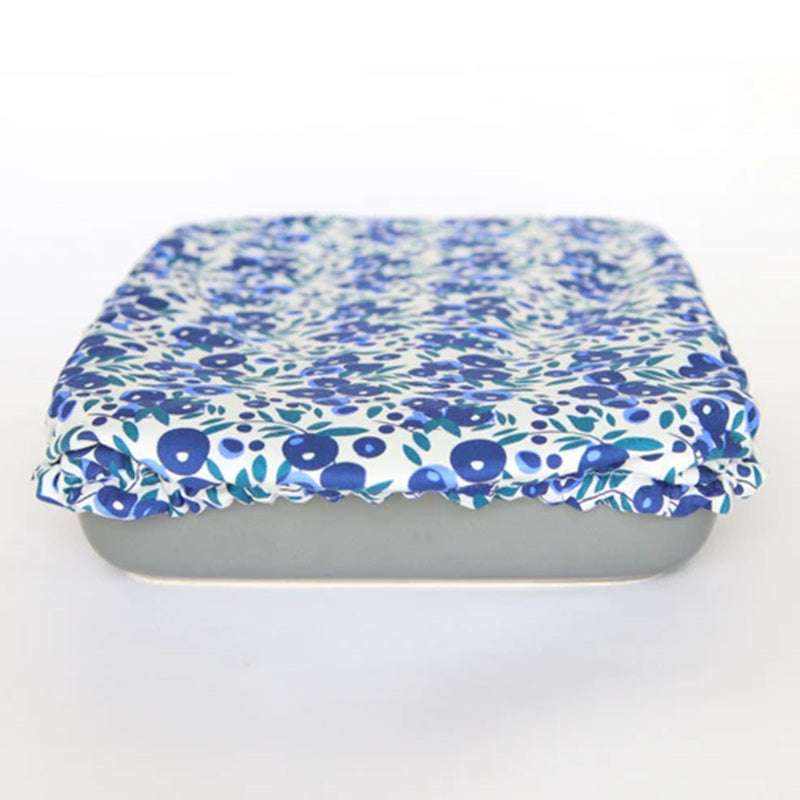 Rectangular container with a blue floral reusable cover on a white background