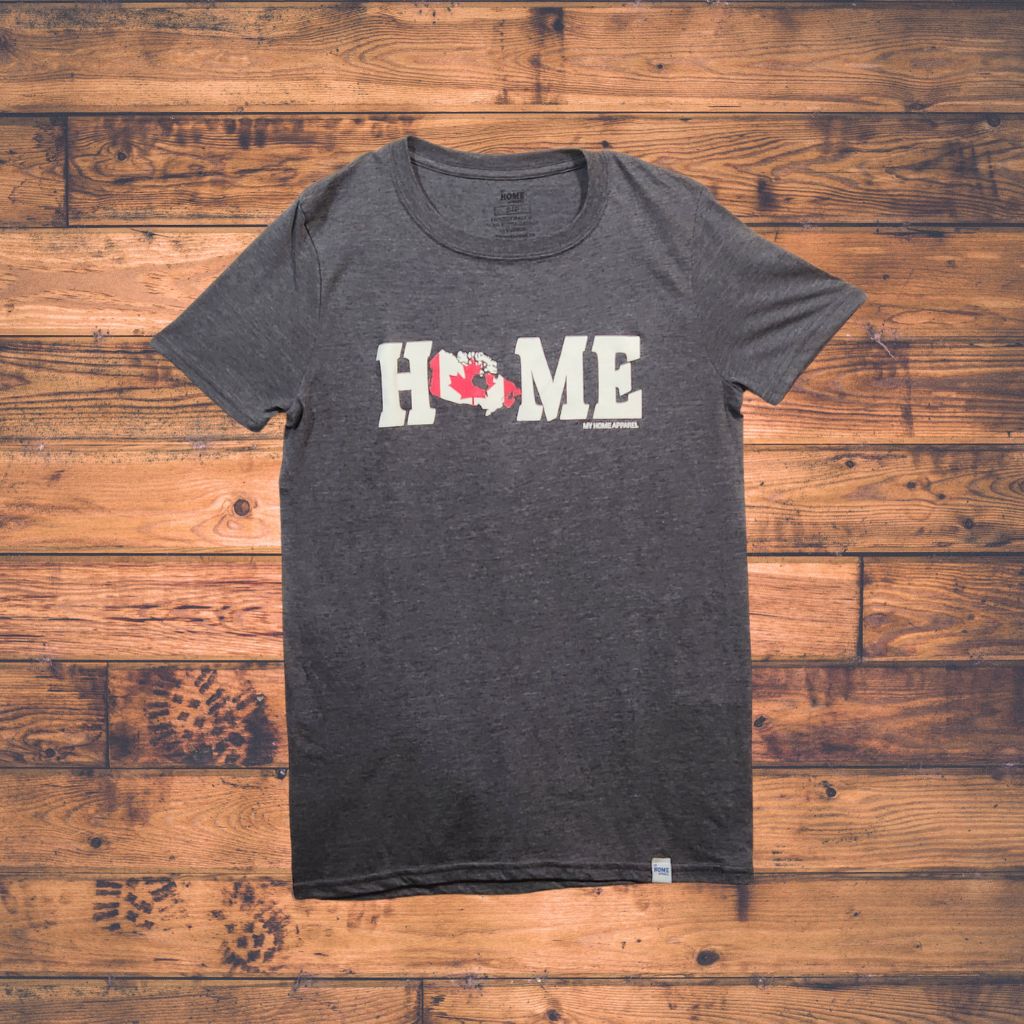 Gray t-shirt with Canada 'HOME' print on a wooden surface