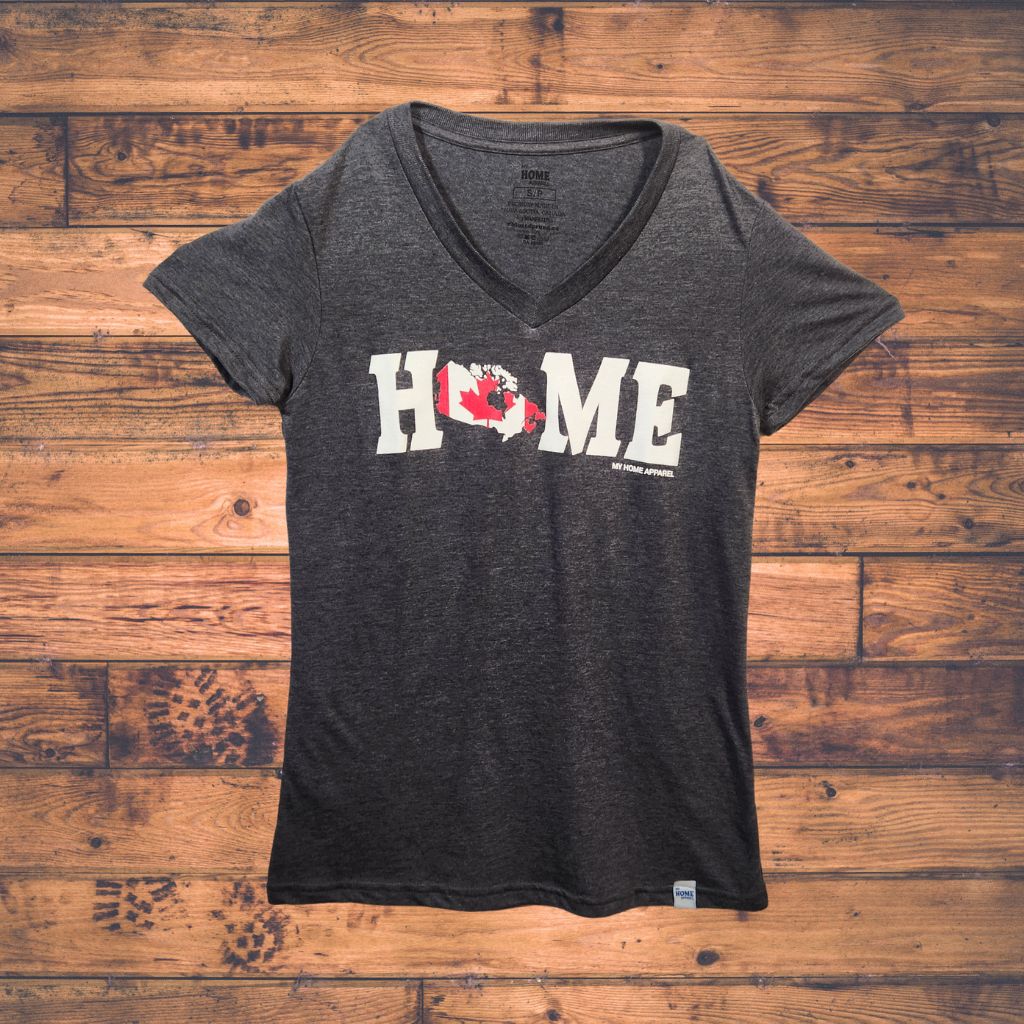 Black v-neck t-shirt with Canada 'HOME' print on a wooden surface