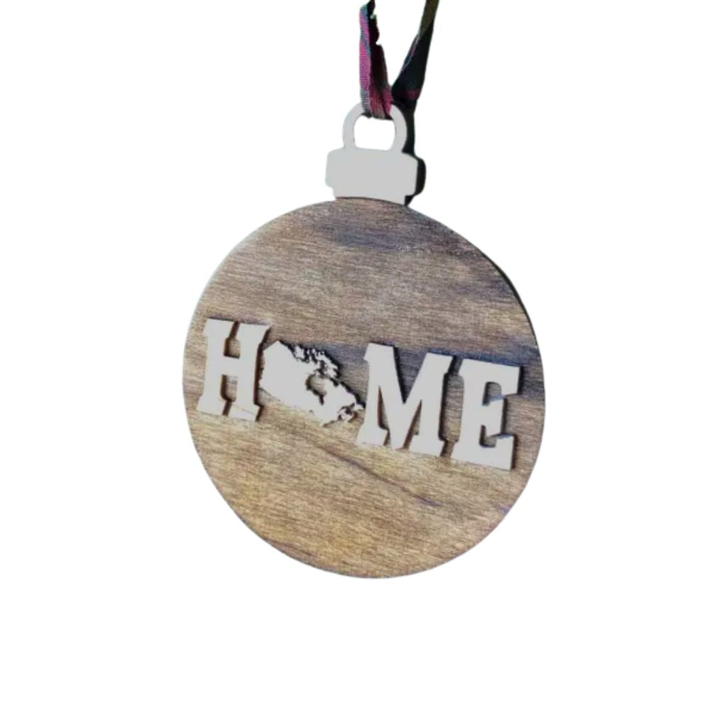 Round wooden ornament with Canada 'HOME' cutout on a white background