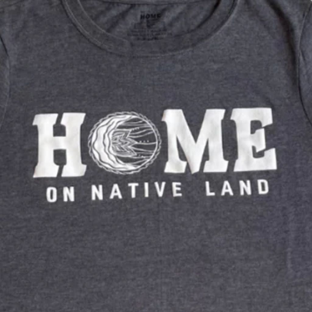 Gray t-shirt with 'HOME on Native Land' text and logo.