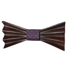 Load image into Gallery viewer, dark brown wood carved in a folded bow tie shape with dark coloured fabric middle with polka dots
