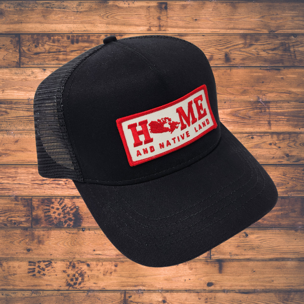 Black cap with a red and white patch on a wooden surface