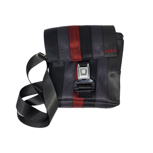 front view of bag made with different coloured seatbelts has a buckle closure