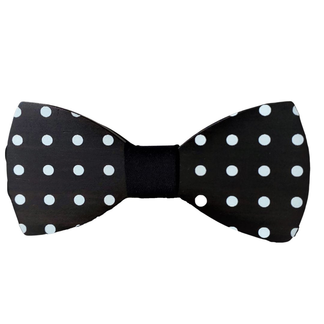 black wood cut in a smooth bow tie shape with white polka dots and dark center