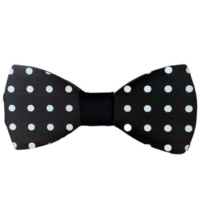 black wood cut in a smooth bow tie shape with white polka dots and dark center