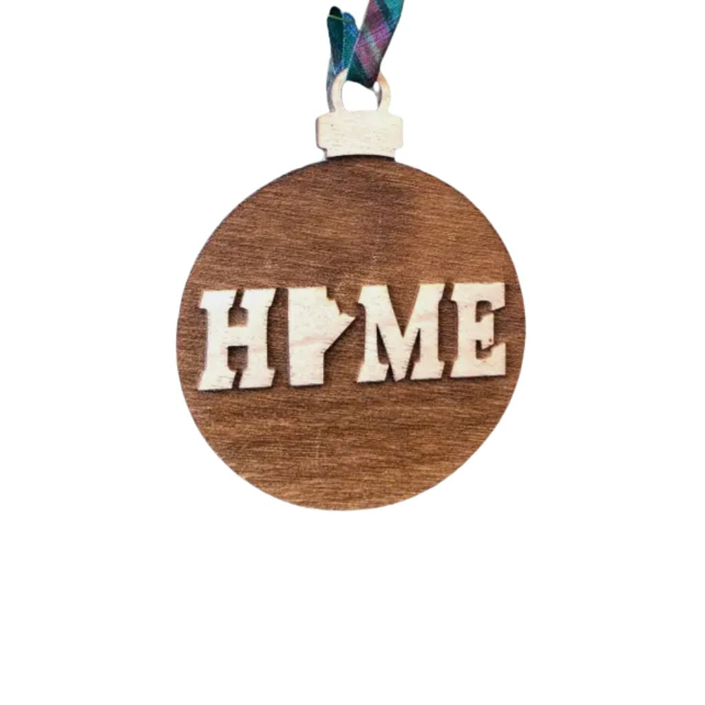 Wooden ornament with Manitoba 'HOME' text on a white background