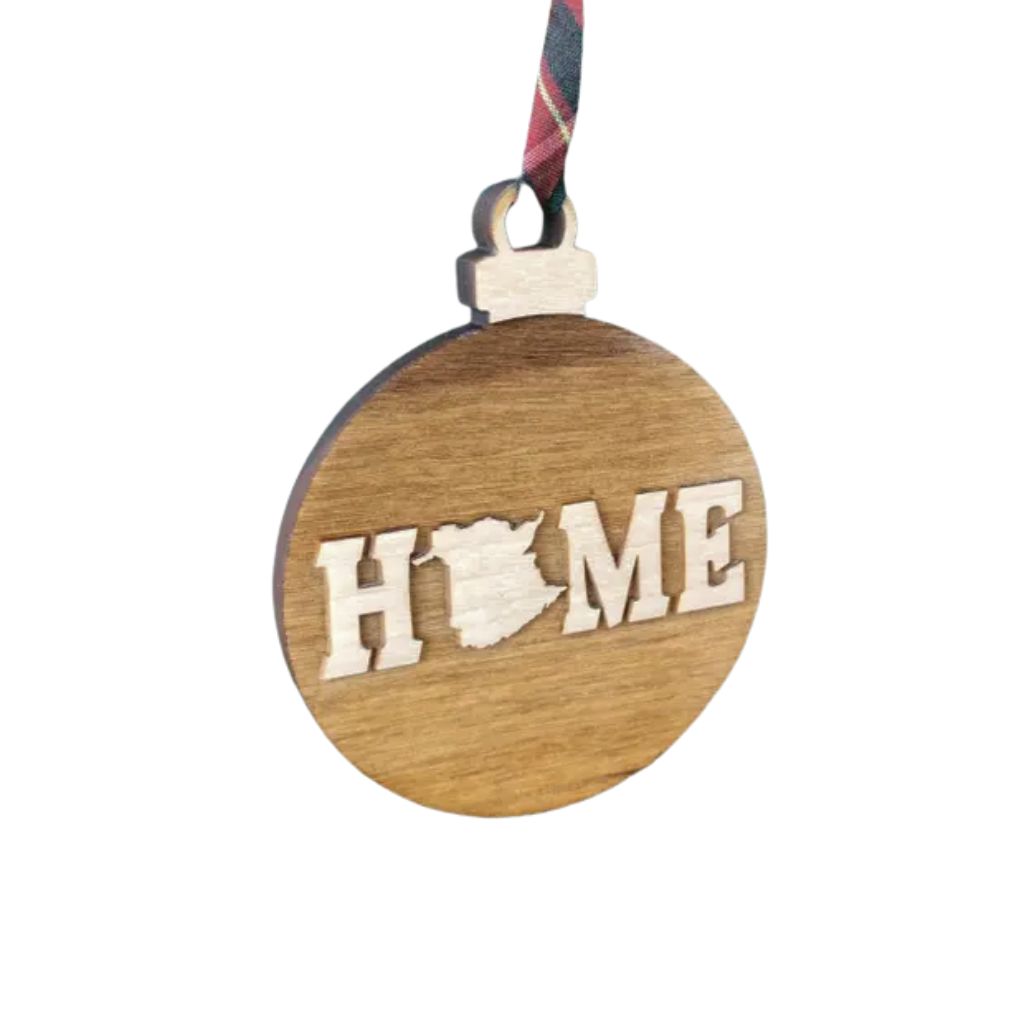 Wooden ornament with New Brunswick 'HOME' cutout on a white background