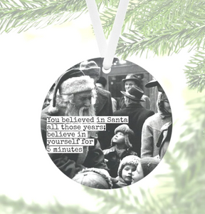 black & white photo, 1950's, printed on a round ornament, Santa & children with adults in background