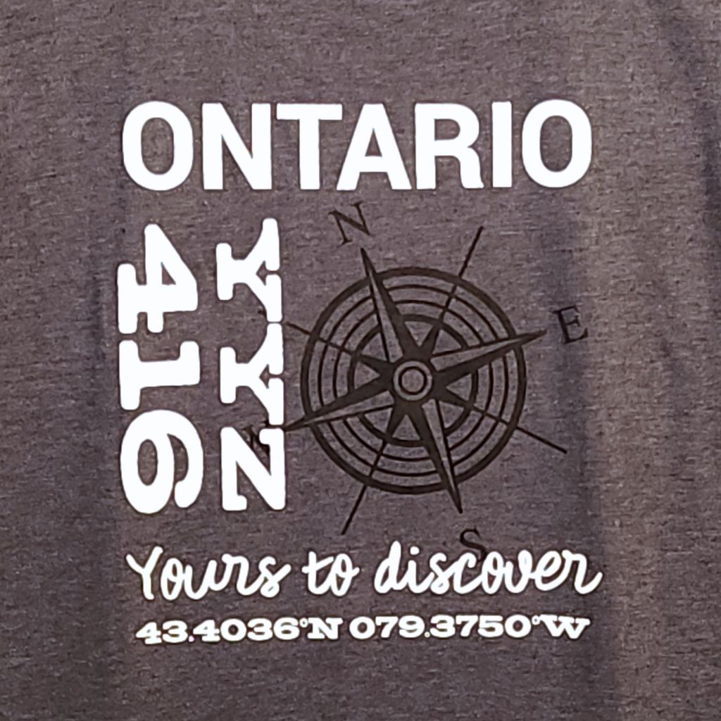 Dark gray t-shirt with white and black text and graphics on a dark gray background