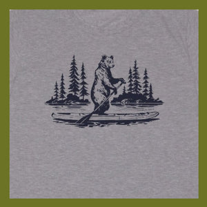 close up of screen printed grey T-Shirt with Bear on paddle board, trees in the background