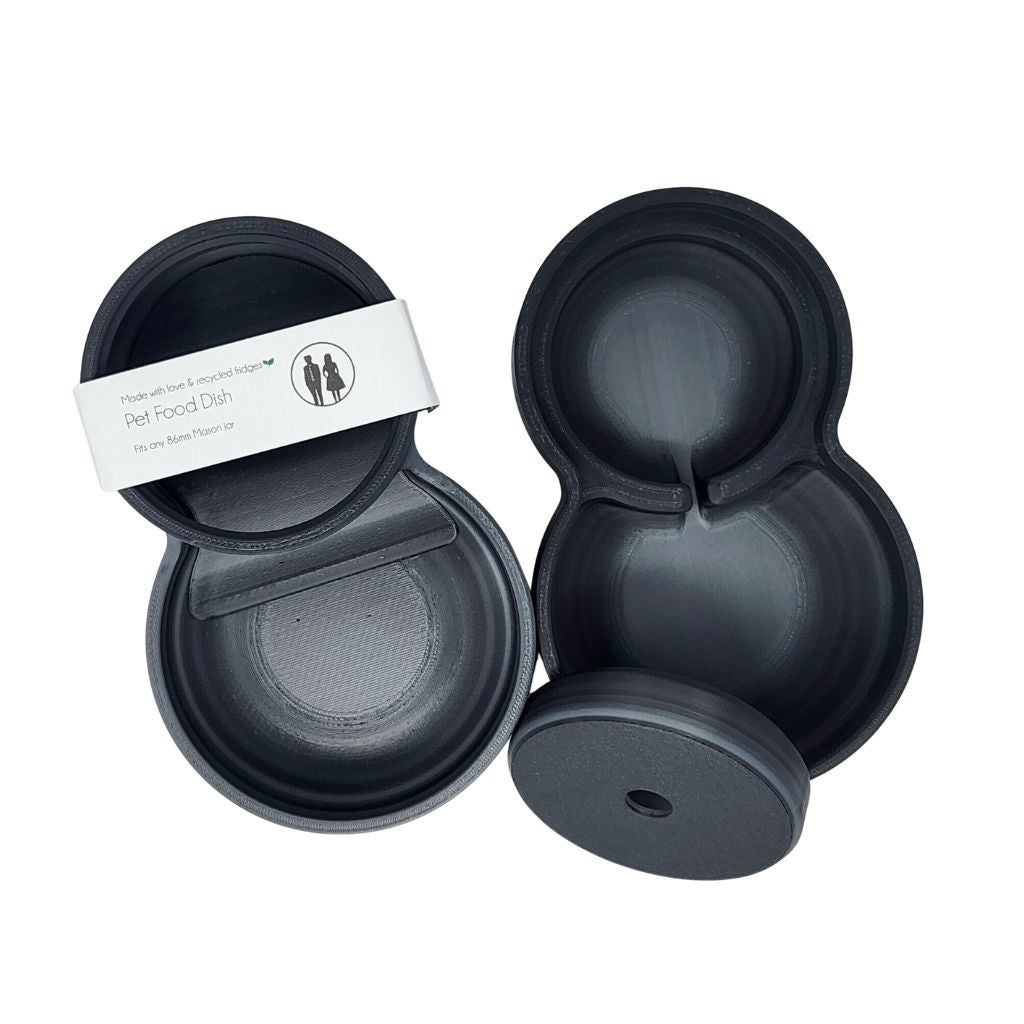 Black pet food dish with a white label on a white background