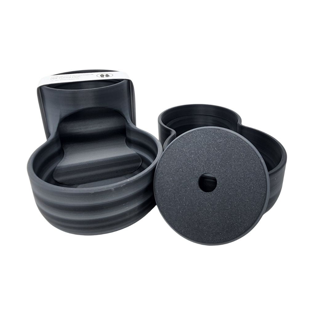 Black pet food dish with a white label on a white background