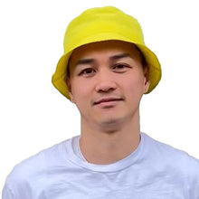 Load image into Gallery viewer, front view of a person wearing a white t-shirt with the nylon yellow bucket hat
