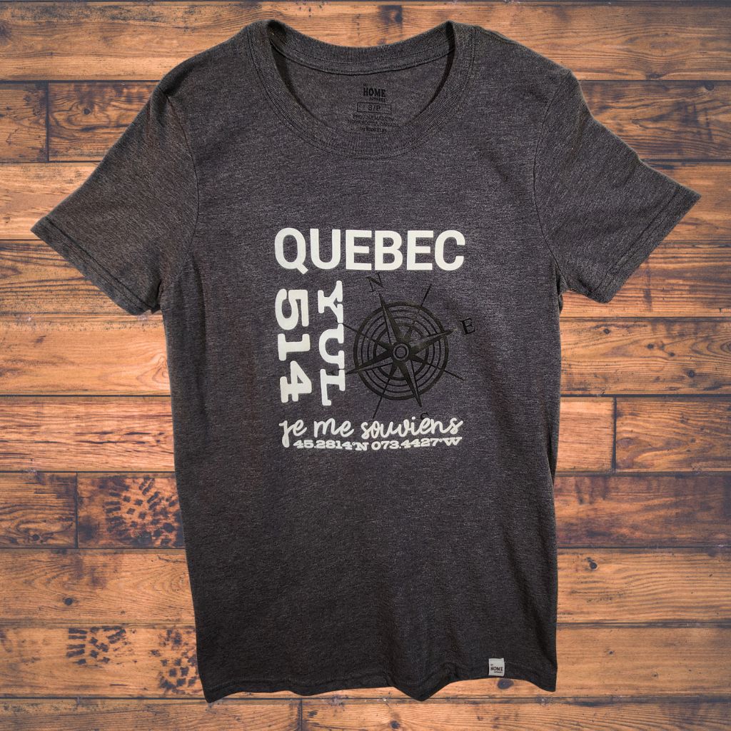 Dark gray t-shirt with white and black text on a wooden surface