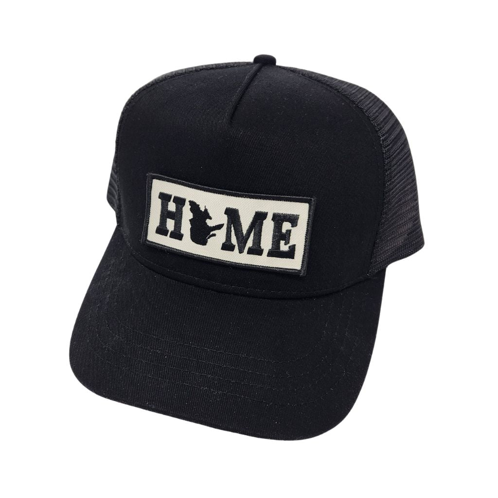 Black trucker cap with Quebec 'HOME' patch on a white background