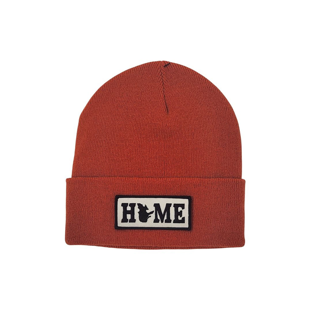 Orange beanie with a patch displaying Quebec'HOME' on a white background