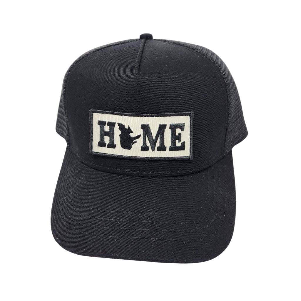 Black trucker cap with Quebec 'HOME' patch on a white background