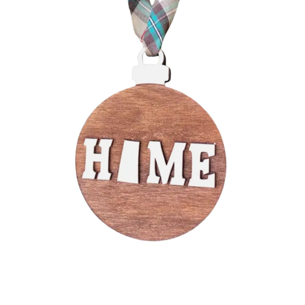 Wooden ornament with Saskatchewan 'HOME' text and plaid ribbon on a white background