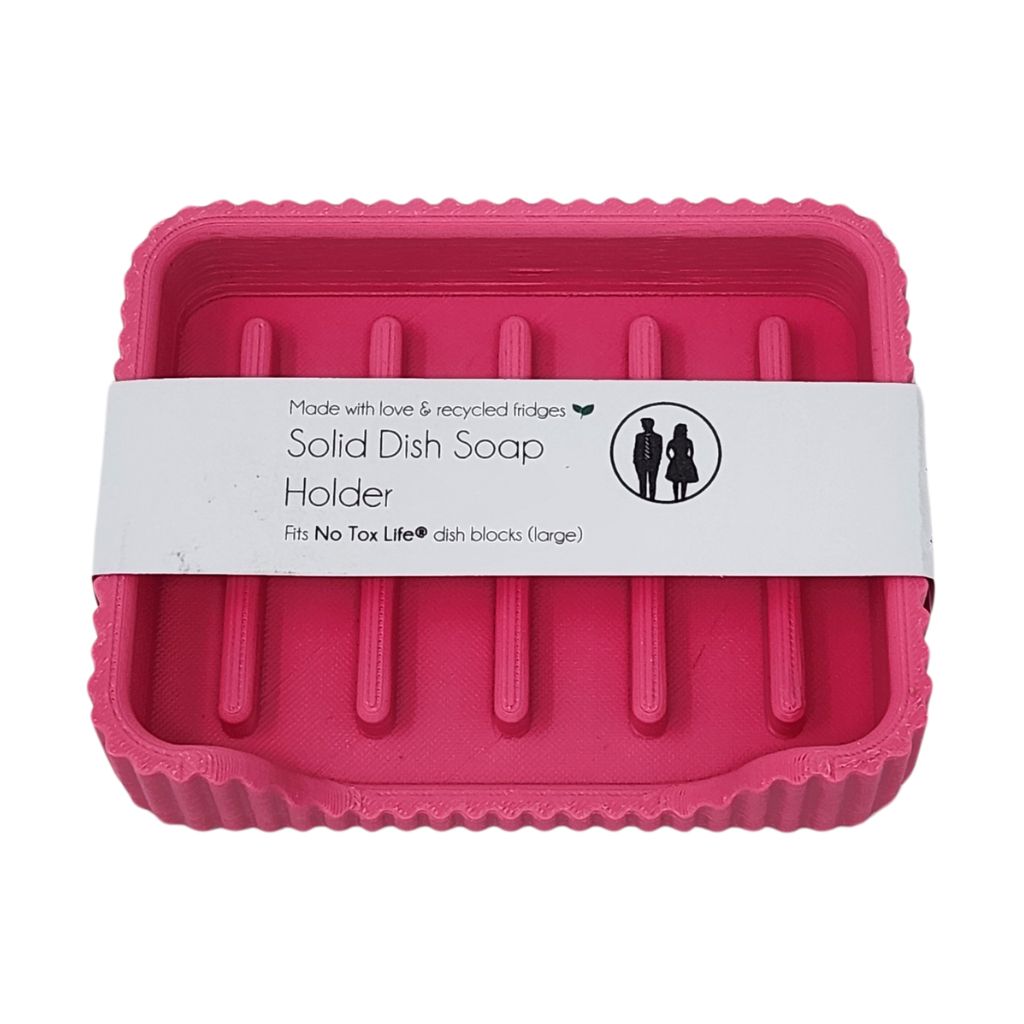 Pink solid dish soap holder with a label on a white background