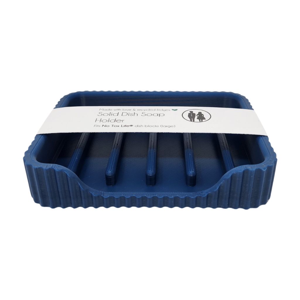 Blue solid dish soap holder with a white label on a white background