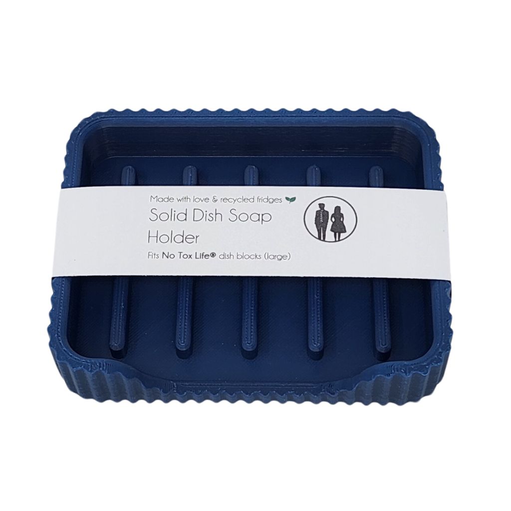 Blue solid dish soap holder with a white label on a white background