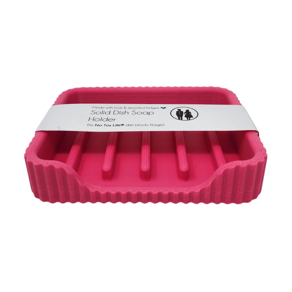 Pink solid dish soap holder with a white label on a white background