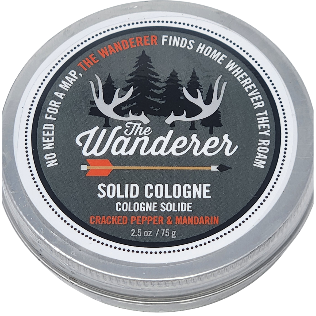 Solid cologne container labeled 'The Wanderer' with deer antlers and forest design.