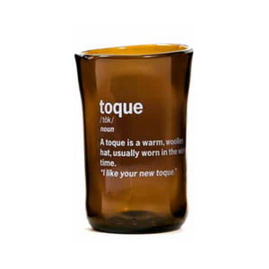 brown glass cup with toque and it's definition printed on it in white