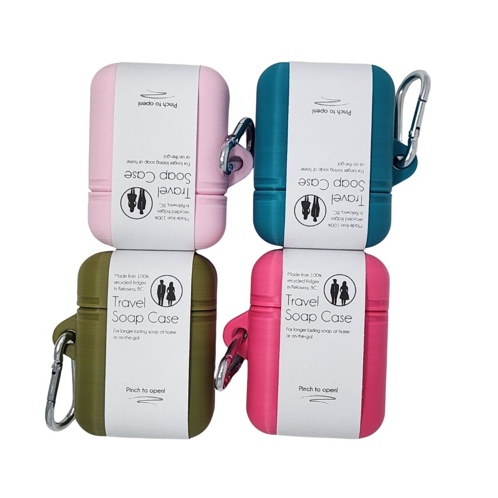 Four travel soap cases in different colors with carabiners on a white background