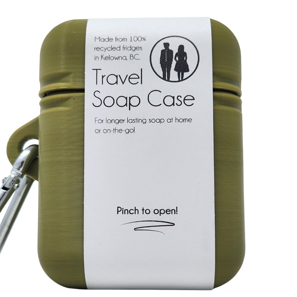 Green travel soap case with a white label on a white background