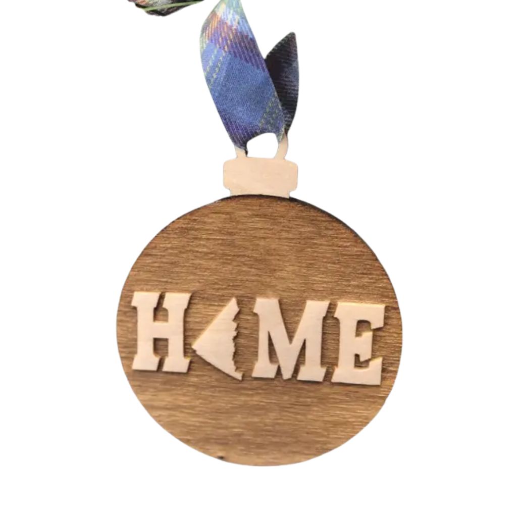 Wooden ornament with Yukon 'HOME' and a heart shape, hanging on a white background