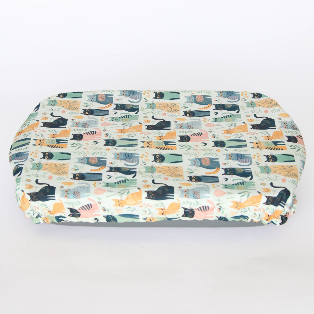 light coloured casserole cover with cat prints covering a dish